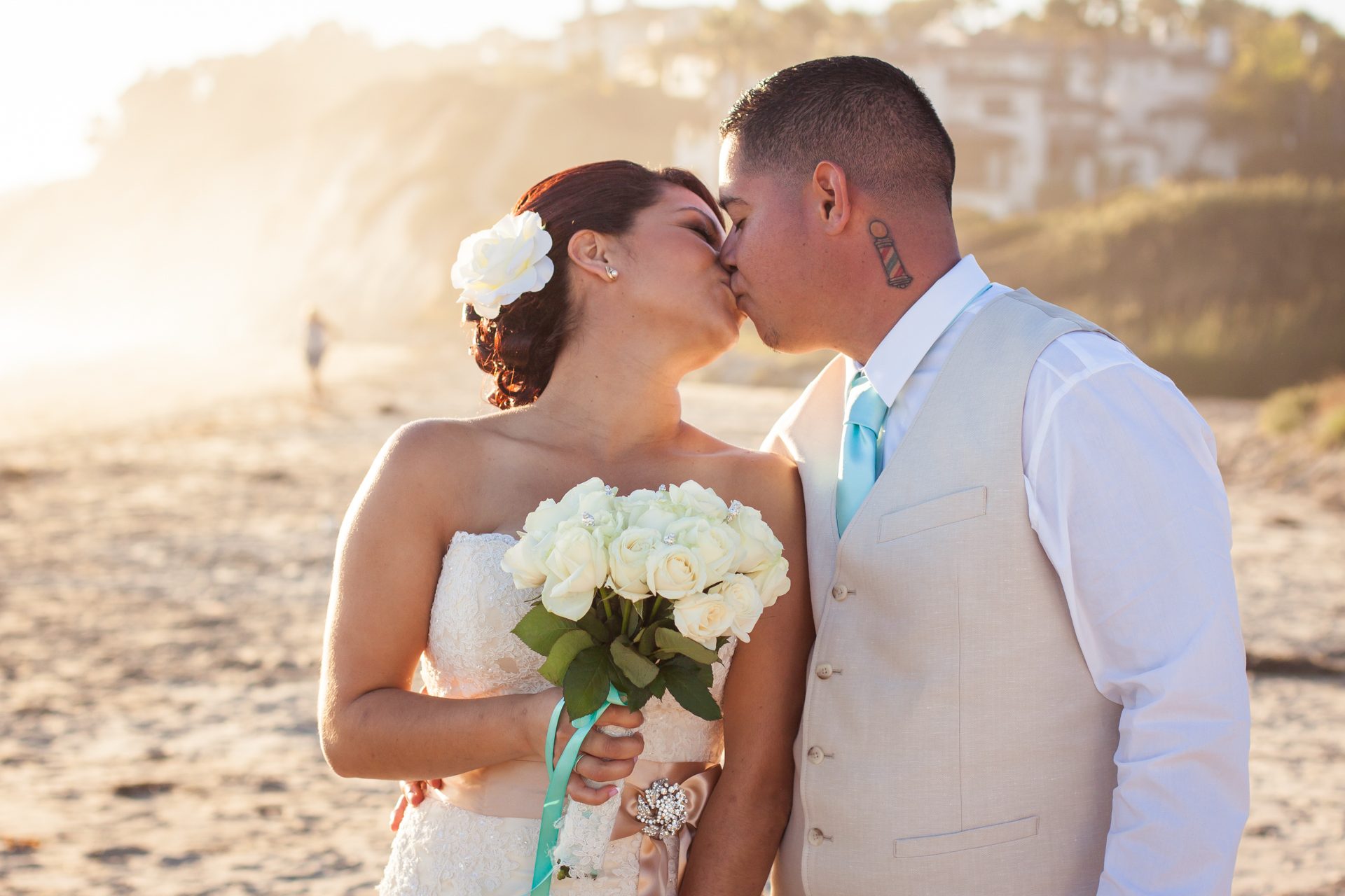 Couple kissing on the beach in golden late-afternoon light